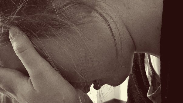 A woman distressed after her partner’s arrest