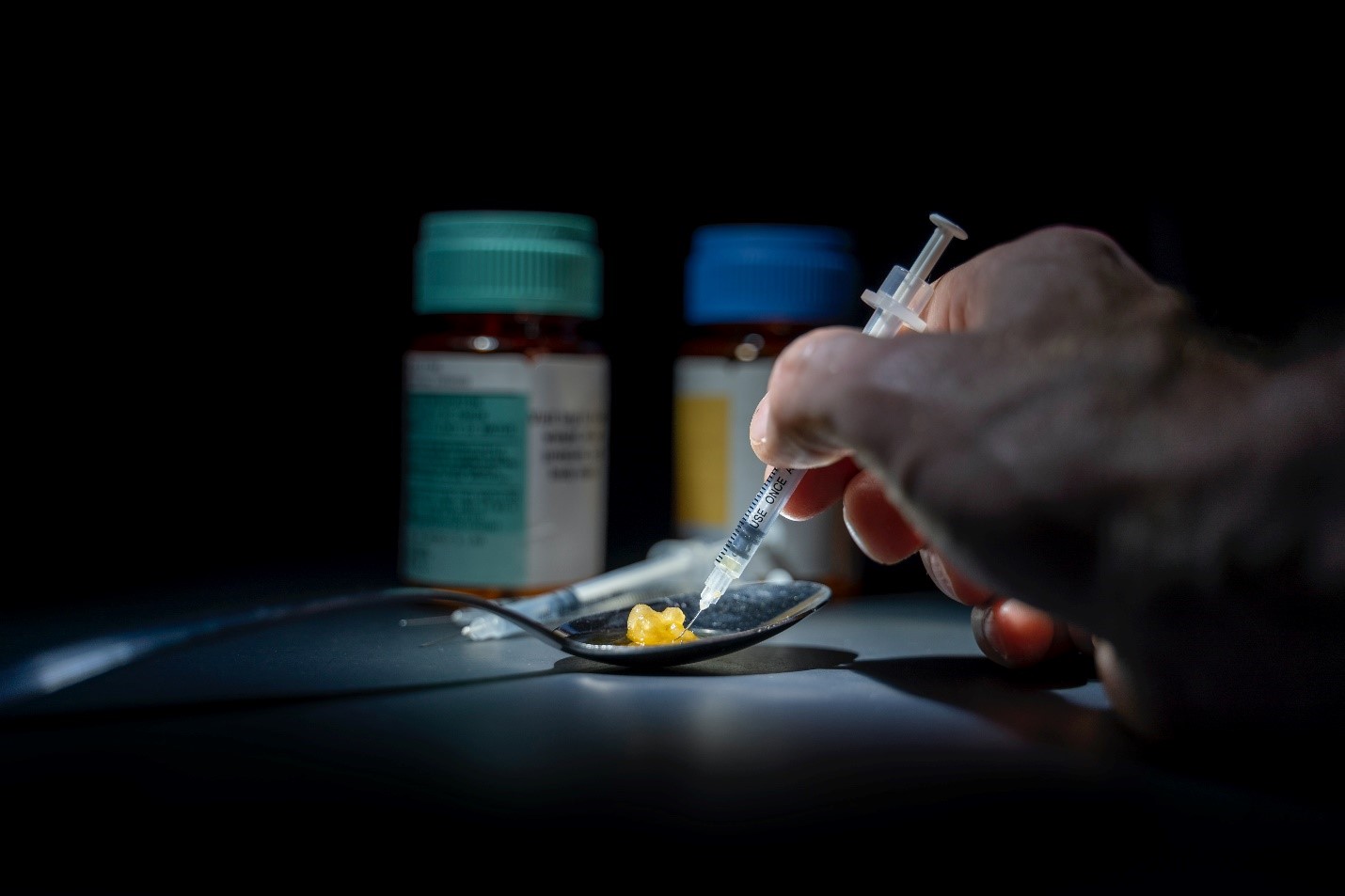 Drugs and syringe on a spoon