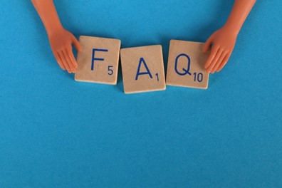 FAQ spelled out on wooden tiles against a blue background.