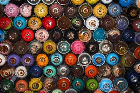 Assortment of spray paints in different colors.