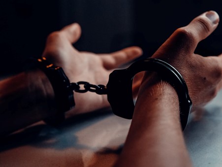 Person in black handcuffs.