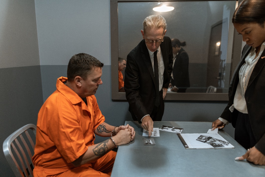 Bail bond agents discussing a transfer bond with a jailed defendant