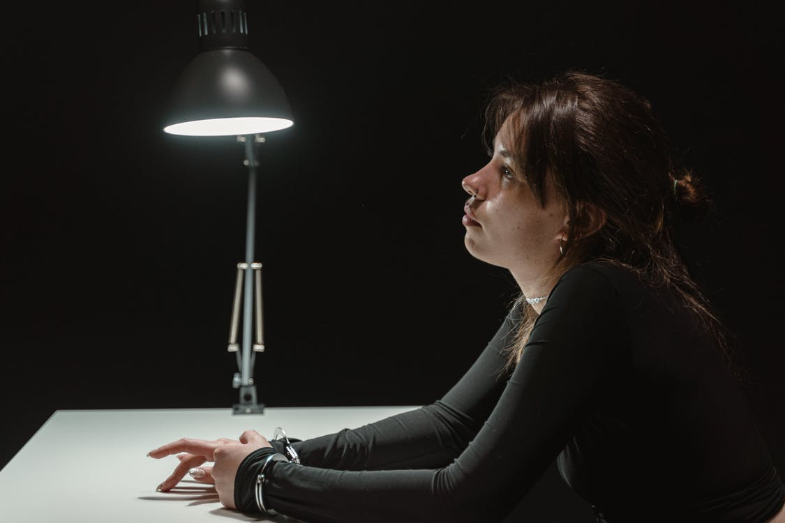 A woman being interrogated. 
