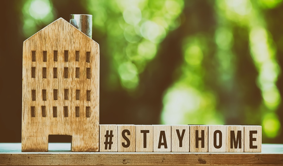A #stayhome sign on blocks beside a house model indicating that traveling is not allowed in the pre-trial home confinement order.