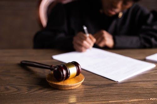 A judge signing papers with gavel placed in the front