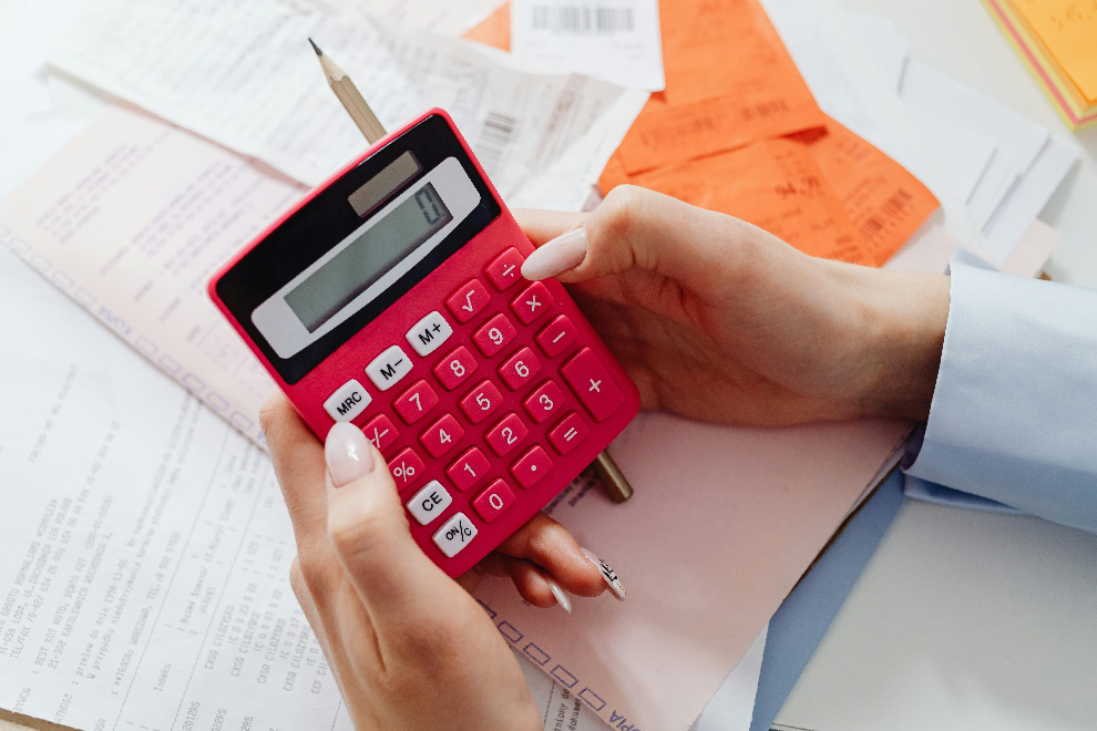  Anonymous woman using a pink calculator 