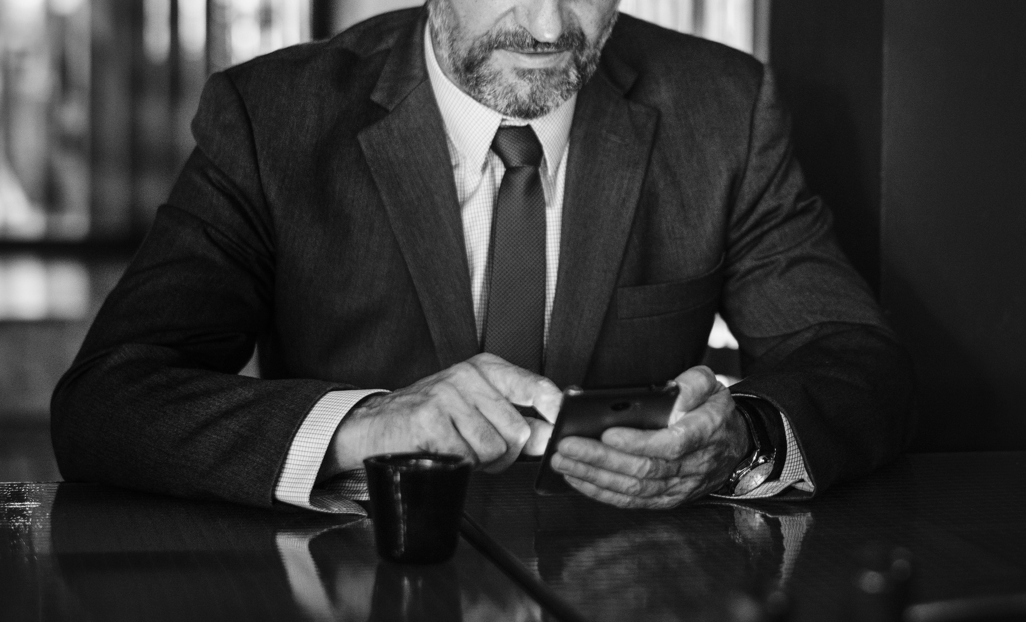 Defense attorney communicating with bail bondsman on mobile phone about bail hearing strategy