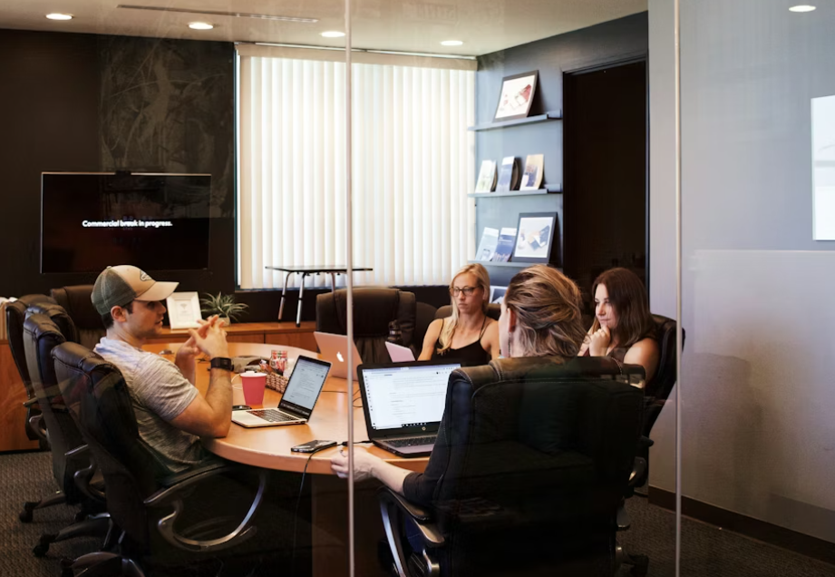 This image shows bail professionals discussing while having laptops.