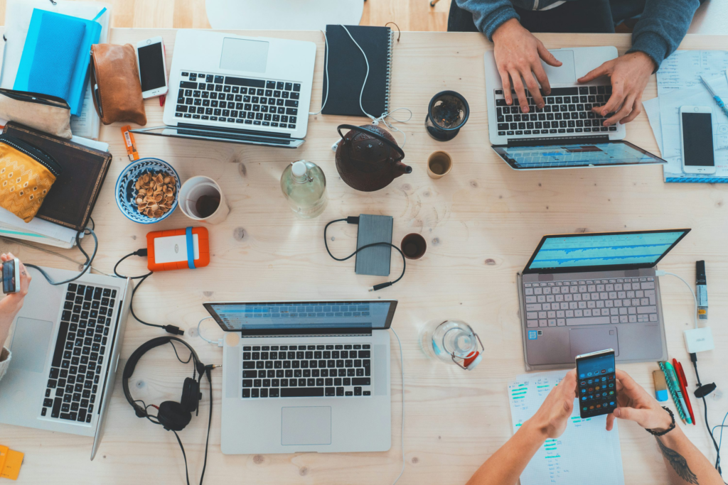  Group of people seated at a table with laptops