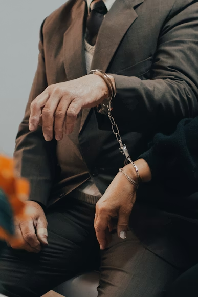 two people wearing handcuffs