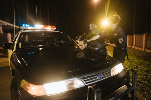 A man being arrested by the police at night