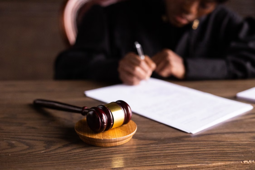 This photo shows a judge signing papers.