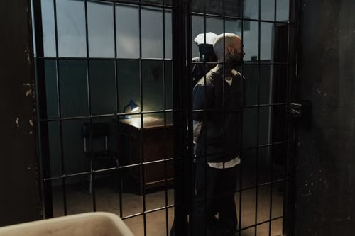This photo shows a policeman with an inmate.