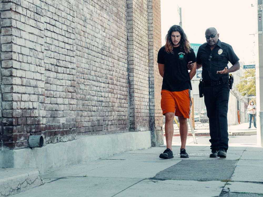  This photo shows a man who has just gotten arrested.