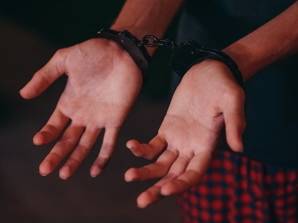Person wearing handcuffs following an arrest in Whitley County