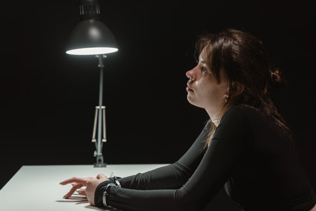Woman in handcuffs during a late-night arrest and questioning