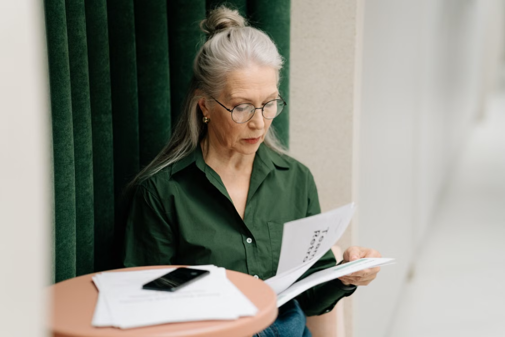 Elderly woman holding papers related to legal and bail bond matters